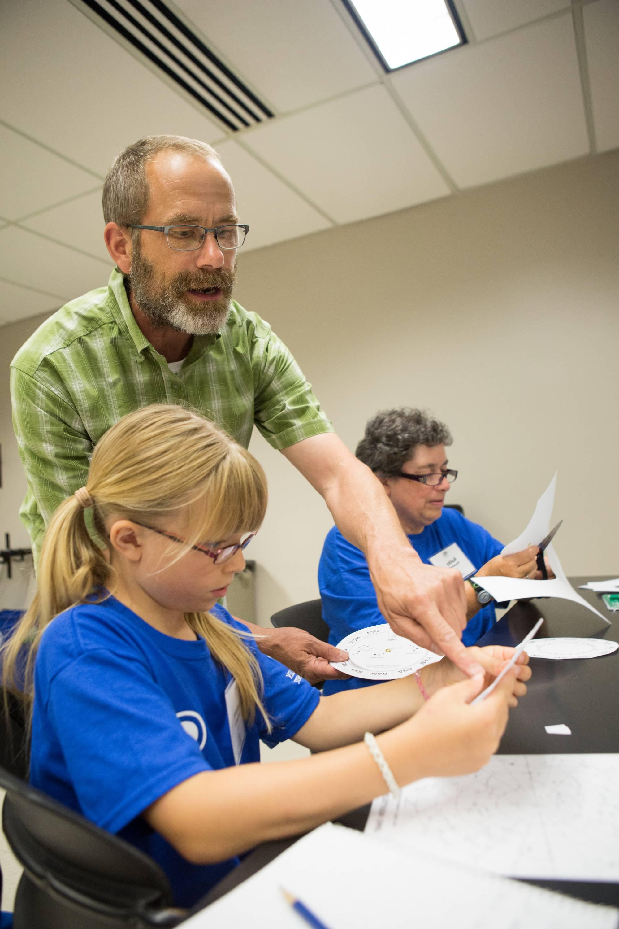 Program Director working with a young camp participant